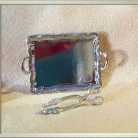 alt="miniature silver serving tray and tongs"